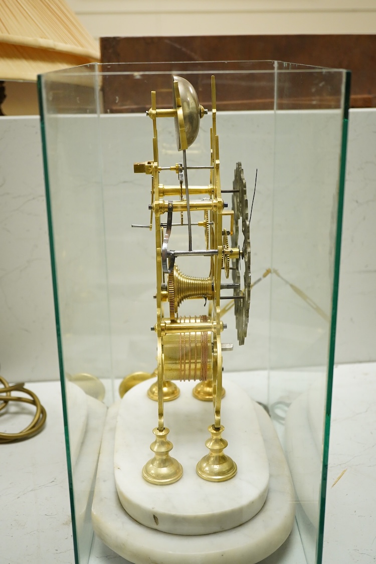 A brass framed skeleton clock, with white marble stand, in glass case, case 39.5cm high